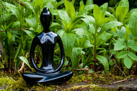 Silhouette young woman practicing yoga and meditating indoors. Sport, healthy, meditation concept.の写真素材
