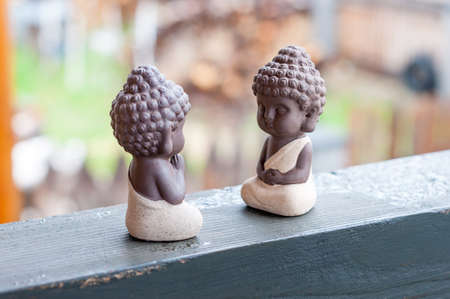 Teacher and follower or pupil ceramic little buddha. Buddhism, Yoga and meditation concept.の写真素材