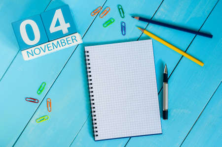 November 4th. Image of november 4 wooden color calendar on blue background. Autumn day. Empty space for text.の写真素材
