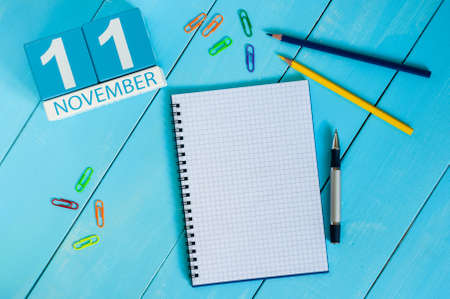 November 11th. Image of november 11 wooden color calendar on blue background. Autumn day. Empty space for text.の写真素材