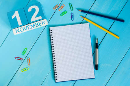 November 12th. Image of november 12 wooden color calendar on blue background. Autumn day. Empty space for text.の写真素材