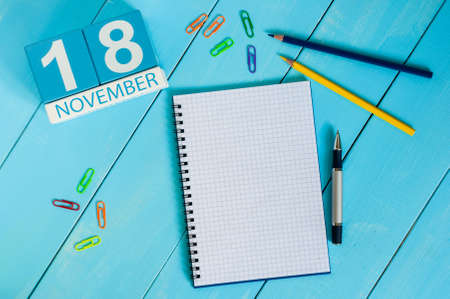 November 18th. Image of november 18 wooden color calendar on blue background. Autumn day. Empty space for text.の写真素材