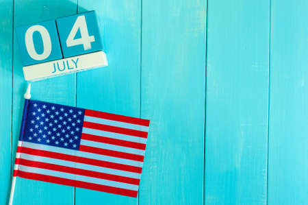 Image of 4th july wooden color calendar with Stars and Stripes flag on blue background.の写真素材