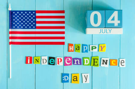 July 4th wooden color calendar with Stars and Stripes flag on blue background.の写真素材