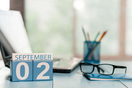 September 2nd. Day 2 of month wooden color calendar on teacher workplace background.の写真素材