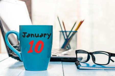 January 10th. Day 10 of month, Calendar on cup morning coffee or tea, workplace background.の写真素材