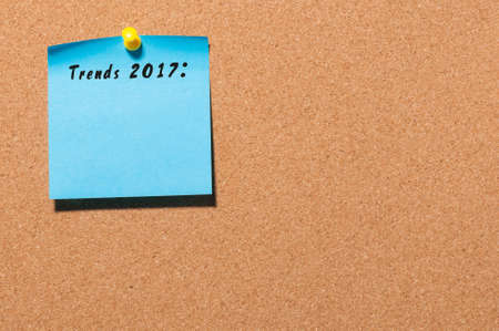 Trends 2017 written on blue sticker pinned at cork notice board with empty space for text. Business concept.の写真素材