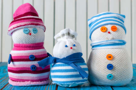 happy young  family snowman at beautiful wooden background.の写真素材