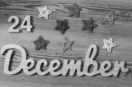Christmas Eve Date On Calendar. December 24. Wooden Background. 24th day of calendar last month of the year.の写真素材