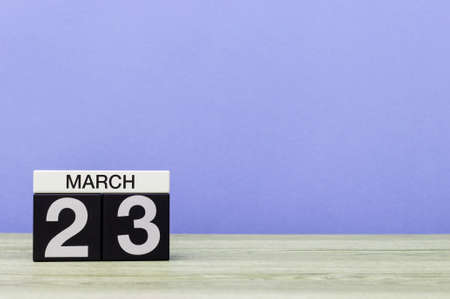 March 23rd. Day 23 of month, calendar on table with purple background. Spring time, empty space for textの写真素材