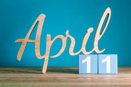 April 11th. Day 11 of month, daily calendar on desk with blue background. Spring time conceptの写真素材