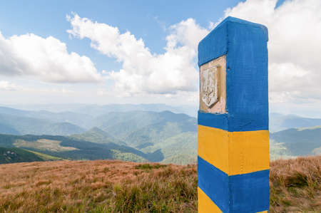 Ukrainian border pillar in Carpatian mountains, as a symbol of visa-free regime with Europe. Open Ukraine and Europian Union travel conceptの写真素材