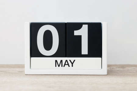 May 1st. Day 1 of month, calendar close-up, at wooden table and white background. Spring timeの写真素材