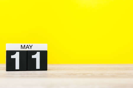 May 11th. Day 11 of month, calendar on yellow background. Spring time, empty space for textの写真素材