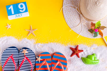 July 19th. Image of july 19 calendar with summer beach accessories and traveler outfit on background. Summer day, Vacation concept.の写真素材