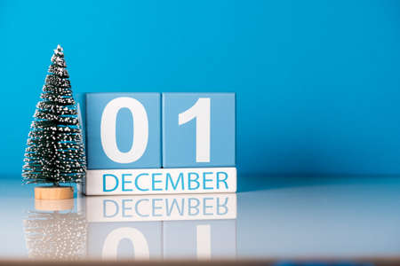 December 1st. Day 1 of december month, calendar with little christmas tree on blue background. Winter time.の写真素材