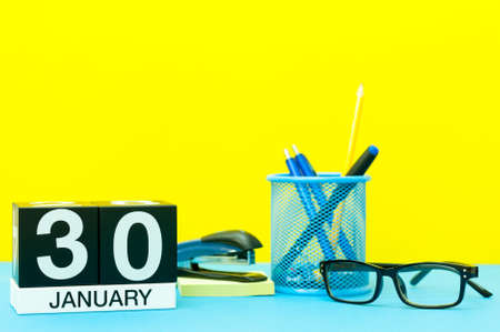 January 30th. Day 30 of january month, calendar on yellow background with office supplies. Winter timeの写真素材
