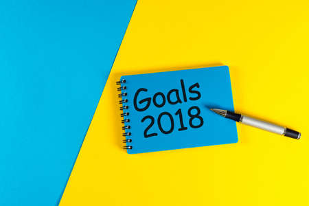 Goals 2018. Life and business goal, plan and resolutions concept for new year concept. Text on note...