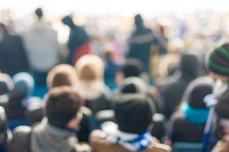 Blurred Crowd of People On stadium or ather populous place, unrecognizable crowded population as blur urban backgroundの写真素材