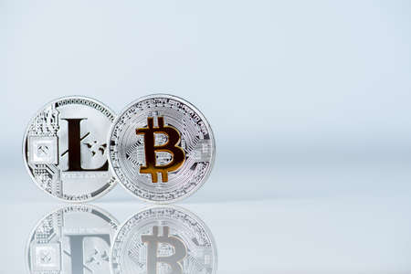 Silver Litecoin and Golden or Diamond Bitcoin cash physical cryptocurrency coin on white background with empty space for text, mockupの写真素材