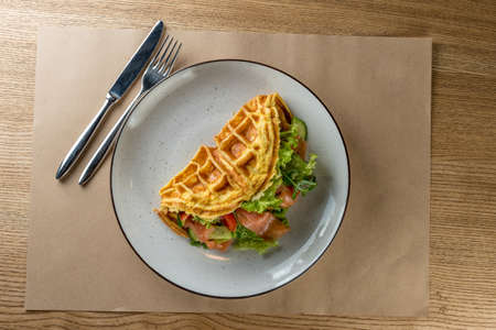 Nutritious and healthy breakfast - Omelet with vegetables, with salad leaves and red fish - salmon. The concept of proper nutritionの写真素材