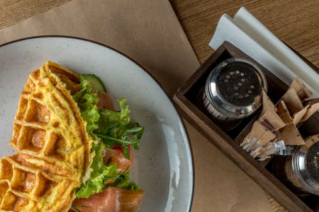 Nutritious and healthy breakfast - Omelet with vegetables, with salad leaves and red fish - salmon....
