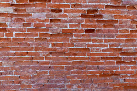 Weathered brick wall background in red tone. Abstract background and pattern.