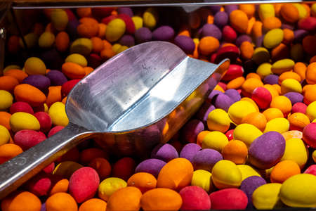 Candies. Variety of candy on a market. Various of colorful sugar candies with a scoop