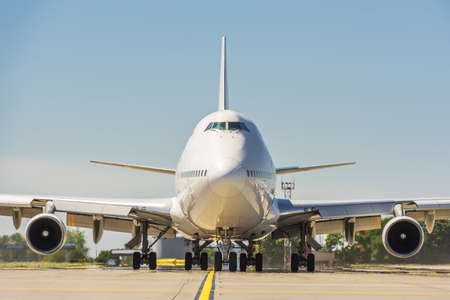 Giant modern civil passenger airliner at airport. Front view of the aircraft. Summer travel conceptの写真素材
