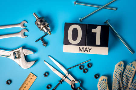 Labor day. May 1st. Day 1 of may month, calendar on blue background with toolsの写真素材