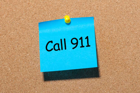 Call 911 - note pinned at corkboard. Concept of healthy lifeの写真素材