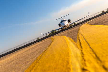 Business private jet airplane on airfield. Ready for take-off. Business and power concept. unique perspectiveの写真素材