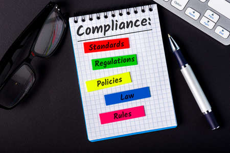 Compliance concept, components of compliance policies at notepad at office workplace.の写真素材