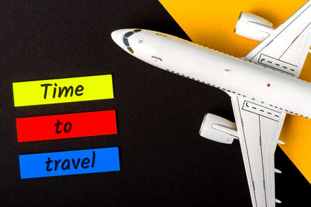 Time to Travel memo near passenger airplane toy model. Summer air traveling conceptの写真素材