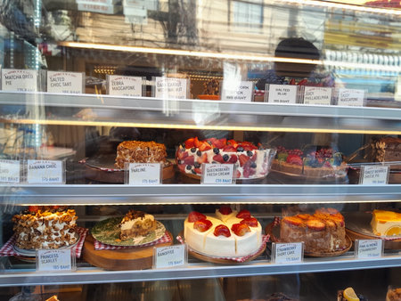 Delicious Homemade Cakes on Display in a Cafe. Pastry shop glass display with selection of cream or fruit cake.の写真素材
