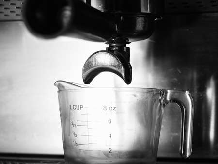 Portafilter and glass on espresso machine, monotone colorの写真素材
