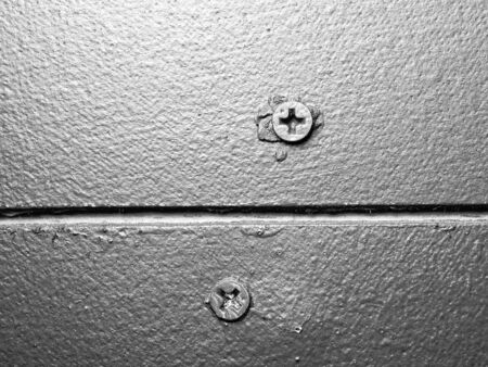 Screw head on brown board ,monotone color backgroundの写真素材