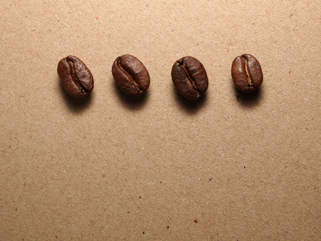 Roasted Coffee Beans on paper texture backgroundの写真素材