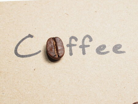 Roasted Coffee Beans on paper texture backgroundの写真素材