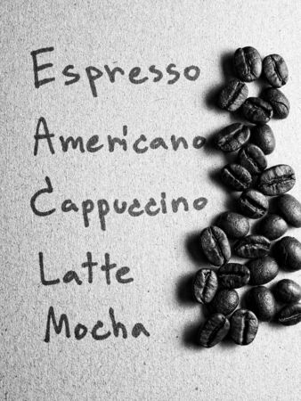 Roasted arabica coffee beans on paper texture with text, retro monotone color backgroundの写真素材