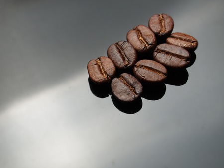 Coffee beans on metal gray plate background