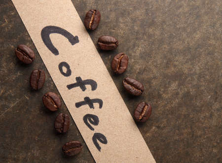 Coffee crop beans with paper on wood texture の写真素材