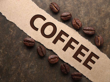 Coffee crop beans with paper on wood texture backgroundの写真素材