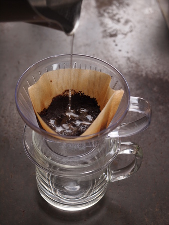 Cup of Dripping fresh hot coffee, blended coffee on paper filterの写真素材