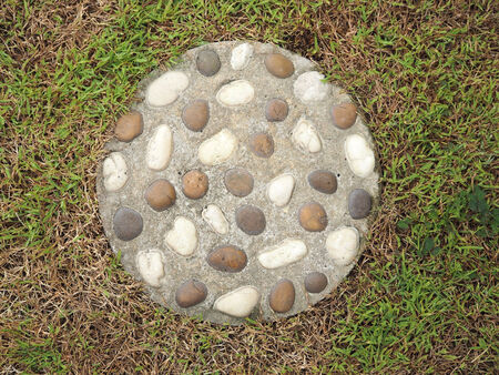 stone in circle concrete on grass texture backgroundの写真素材