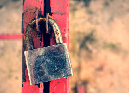 old and corroded padlock on steel, vintage color backgroundの写真素材