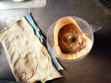 Cup of Dripping fresh hot coffee, blended coffee on paper filterの写真素材