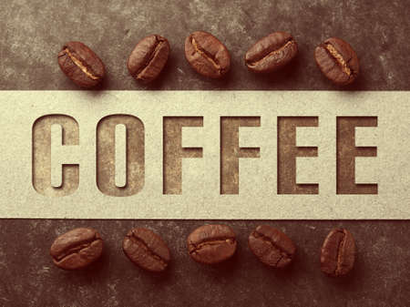 Coffee crop beans with paper and text on wood texture, vintage color backgroundの写真素材