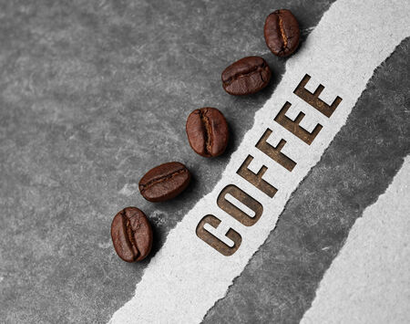 Coffee crop beans with paper and text on wood texture backgroundの写真素材