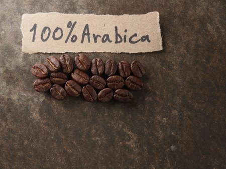 Coffee crop beans with text paper on wood texture backgroundの写真素材